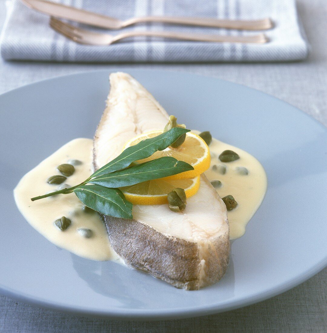 Halibut cutlet in caper sauce with lemons and bay leaf