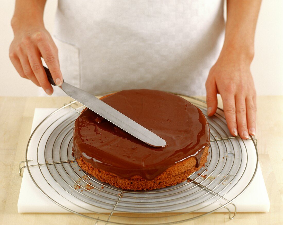 Smoothing chocolate icing with palette knife