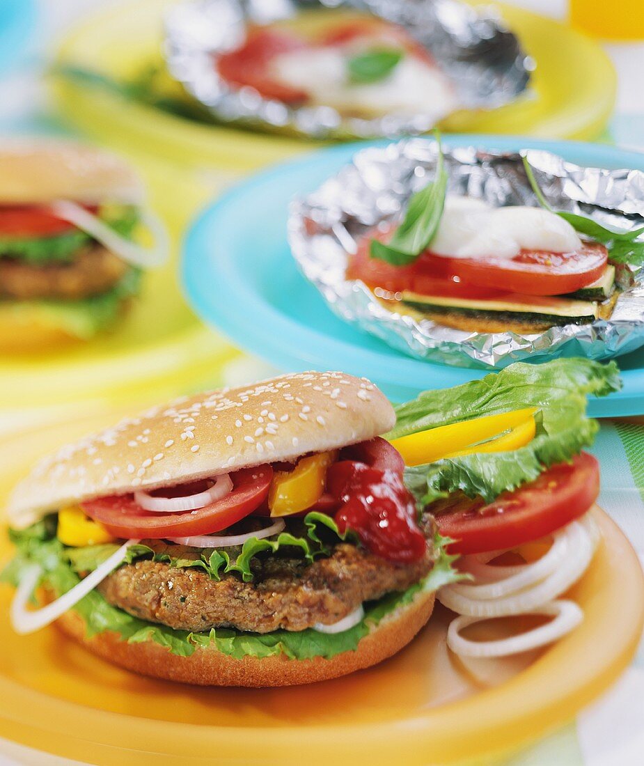 Home-made hamburgers and barbecued vegetables parcels