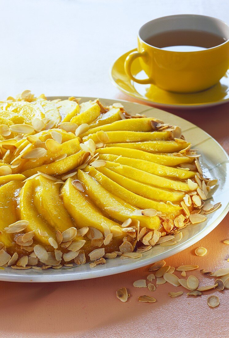 Mango cake with flaked almonds