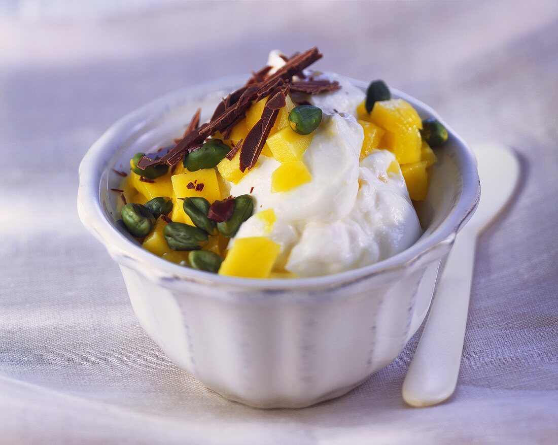 Mango quark with pistachios and chocolate curls