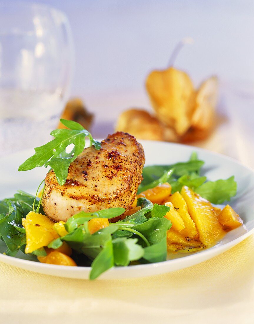Pork fillet on rocket with physalis and oranges
