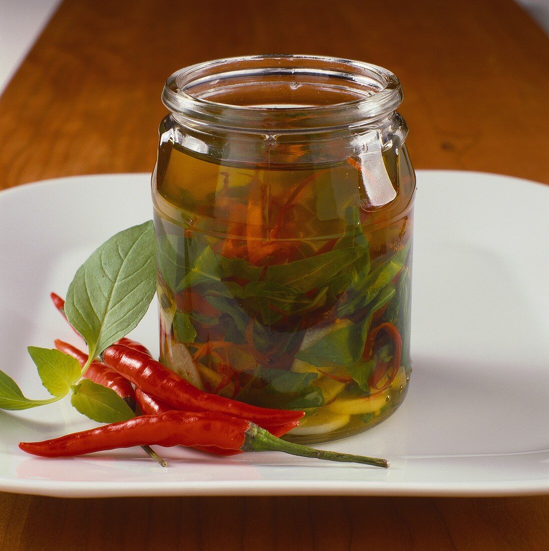 Chili peppers and basil in oil