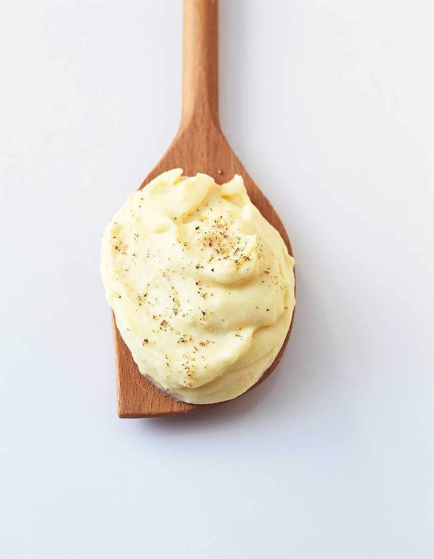 A spoonful of mashed potato with cheese