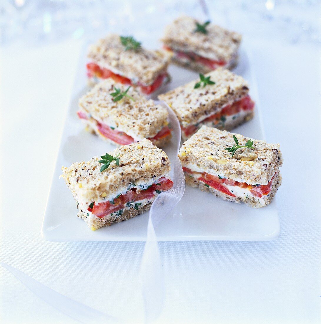 Small tomato and soft cheese sandwiches