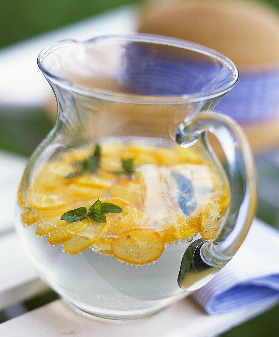 Lemonade with kumquats in a carafe