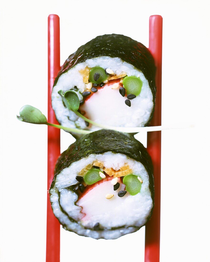 Two maki-sushi with surimi and green asparagus