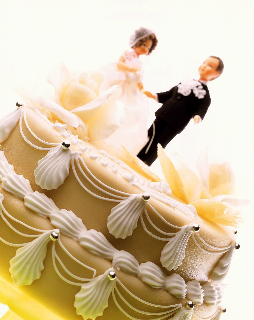 Decorated marzipan-covered cake with bride and groom
