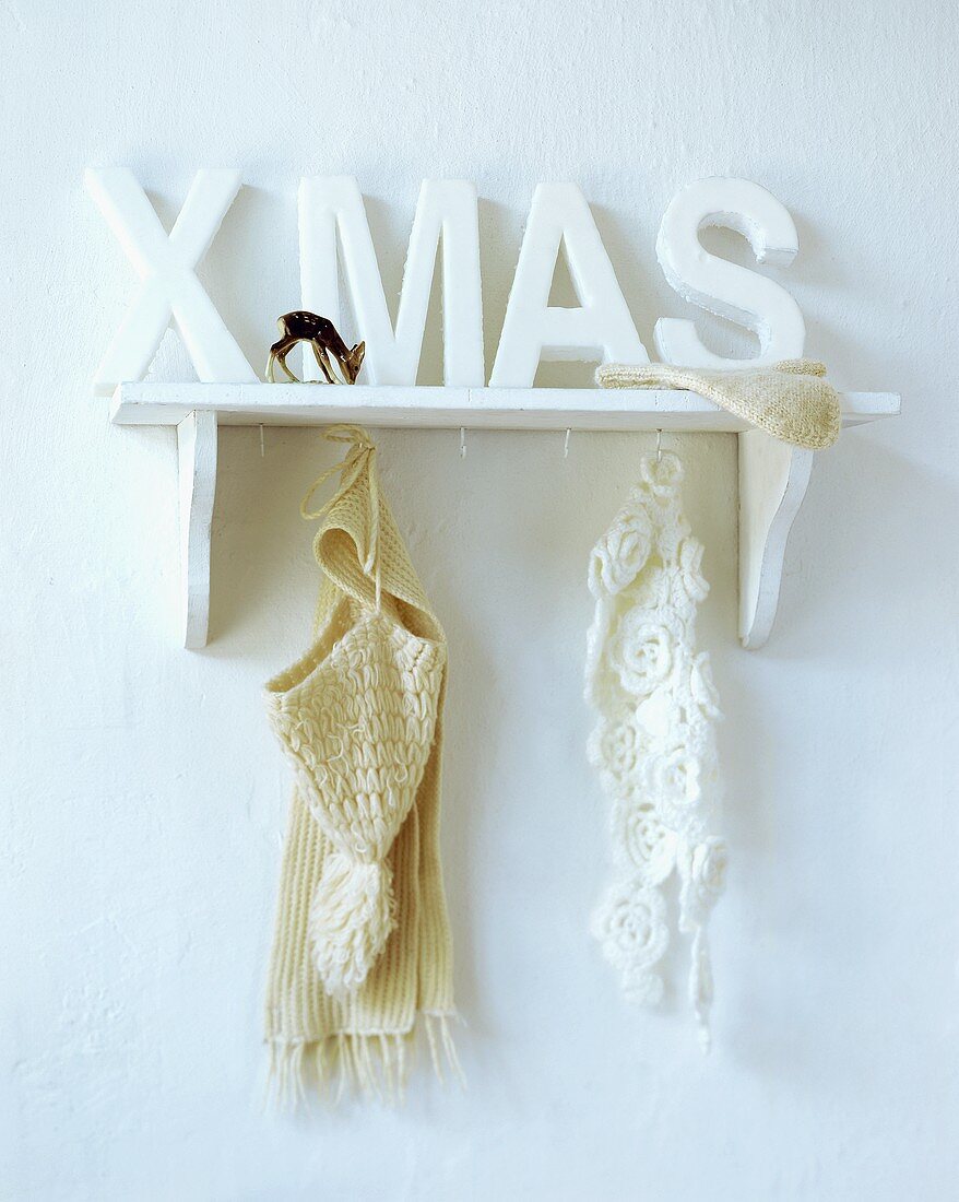 Wall shelf with the word Xmas, scarves, cap and glove