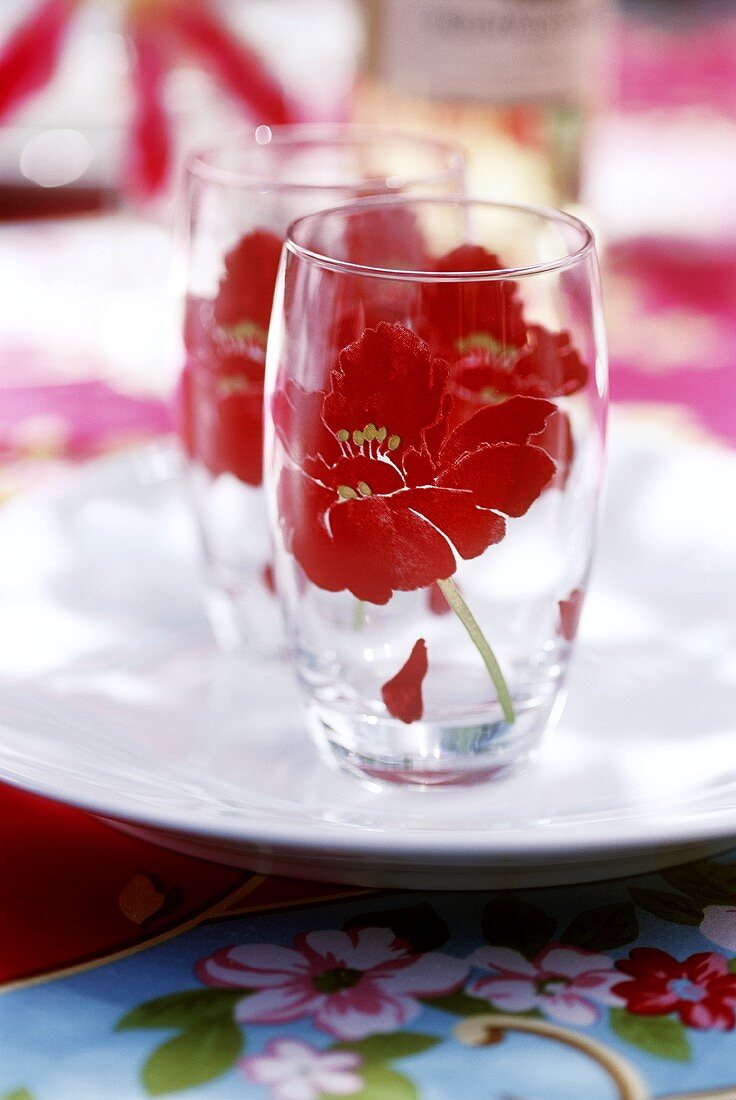 Two glasses with flower design on white plate