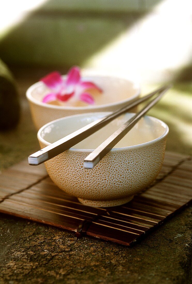 Bowl with chopsticks and with flower