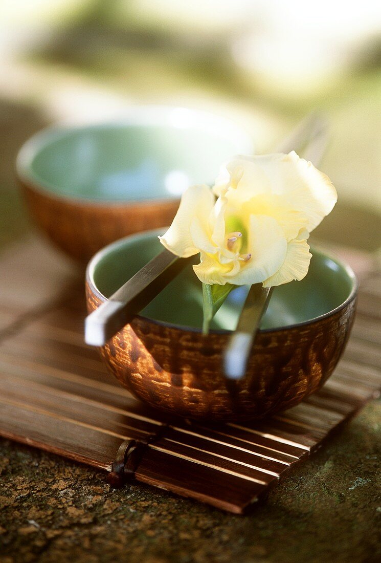 Bowl with chopsticks and flower