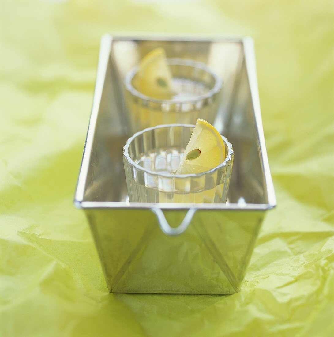 Two glasses of vodka jelly in a loaf tin