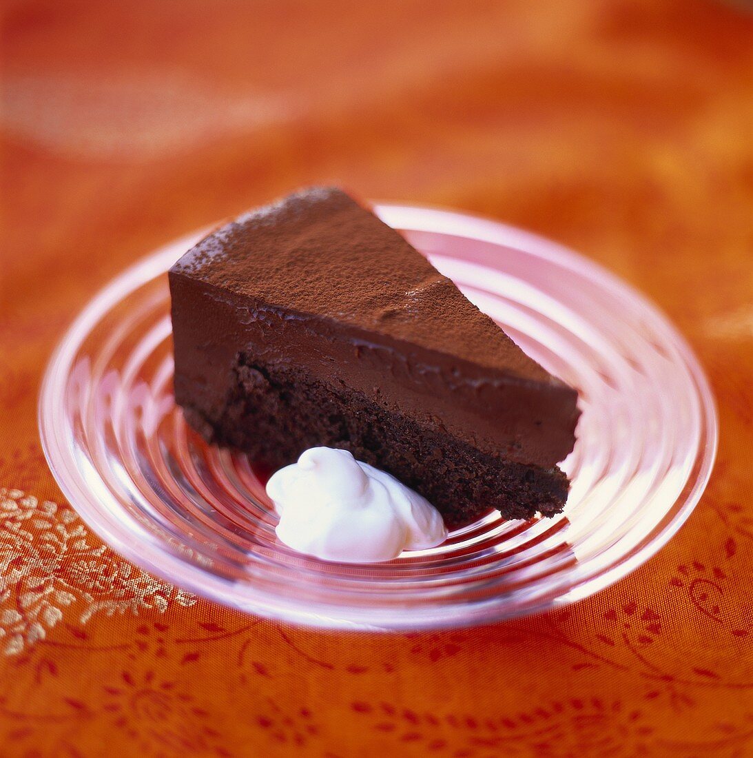 A piece of chocolate cake with cream