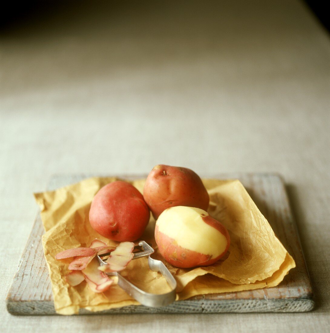 Half-peeled and unpeeled potatoes