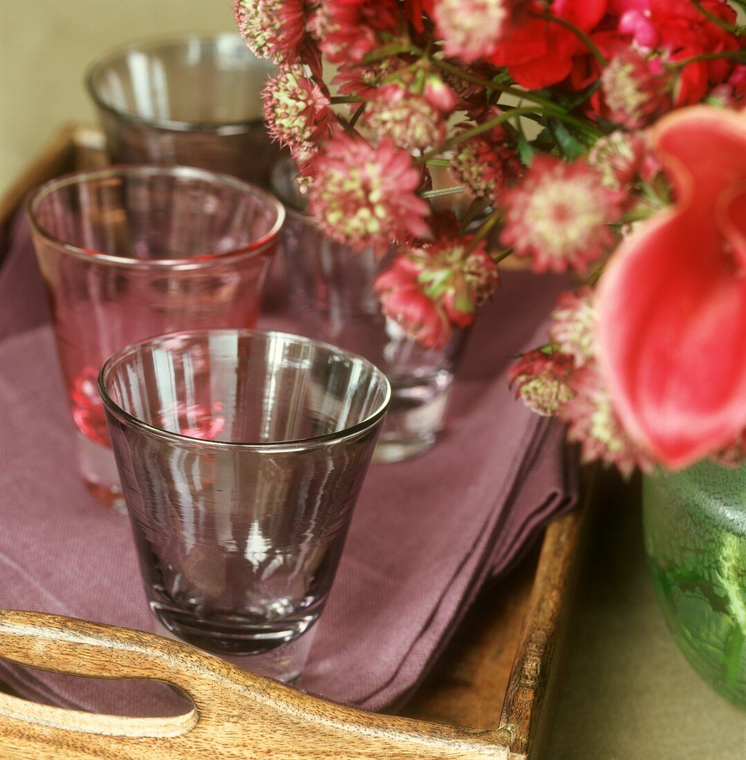 Empty water glasses on a wooden tray