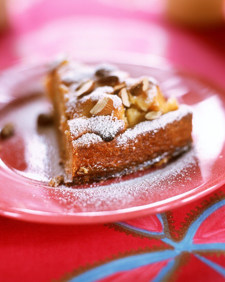A piece of apple cake with marzipan and almonds