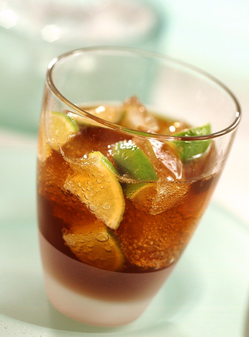 Cuba Libre with lime wedges in glass