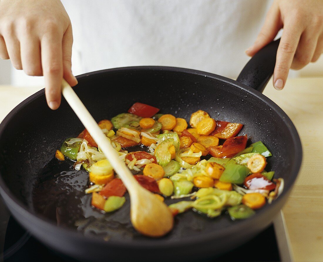 Sautéing vegetables in a frying pan