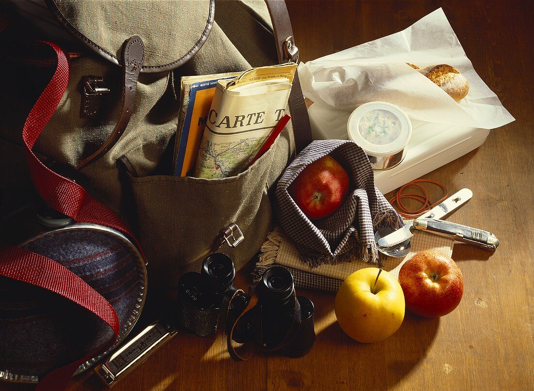 Still life with rucksack, binoculars and provisions