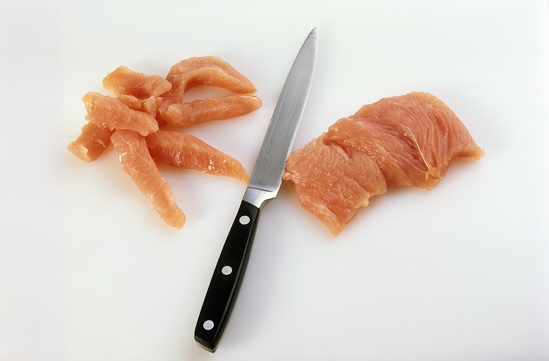 Cutting pork into thin strips