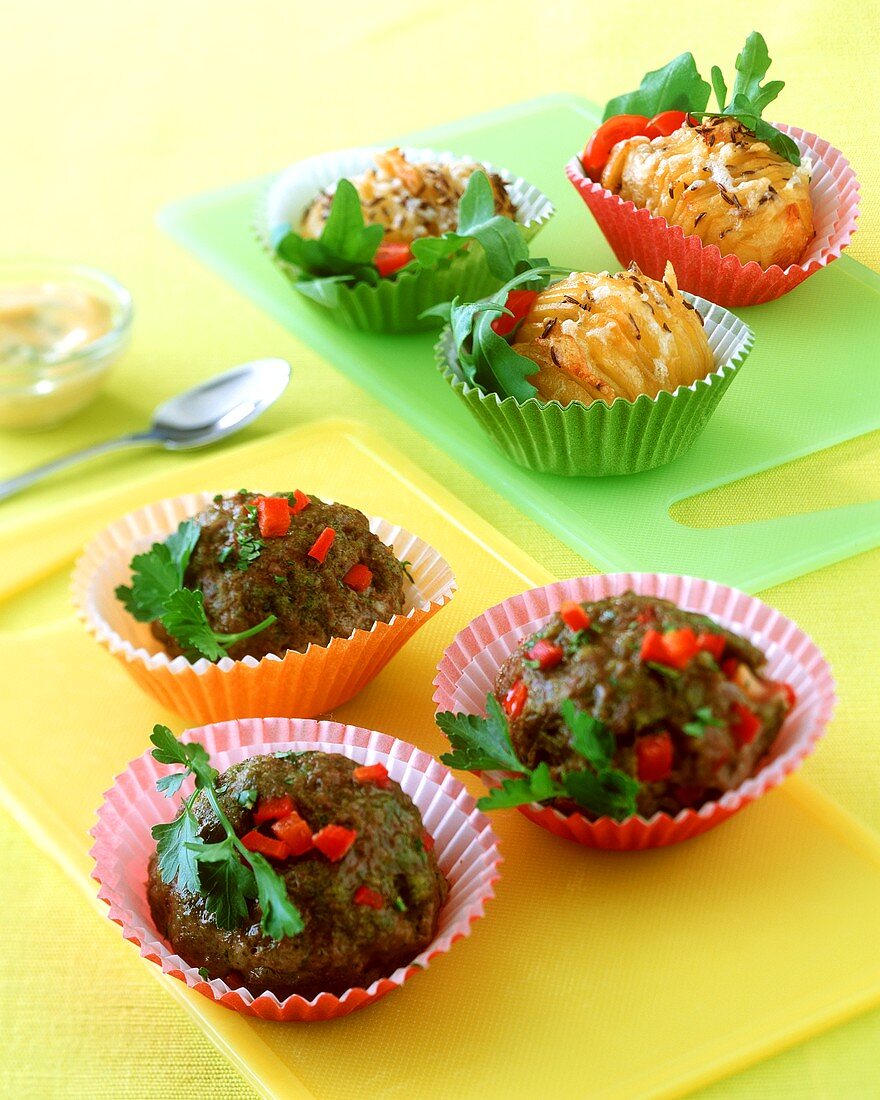 Mini-meat loaves and baked cheese potatoes in muffin cases