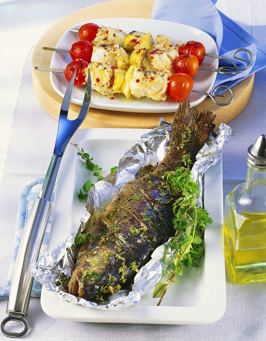 Barbecued trout with herbs and fish and banana kebabs