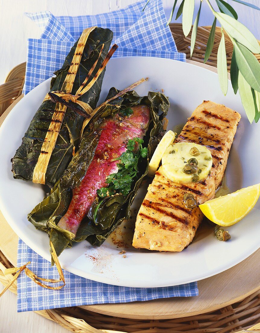Fish in vine leaves and salmon with lemon and caper butter