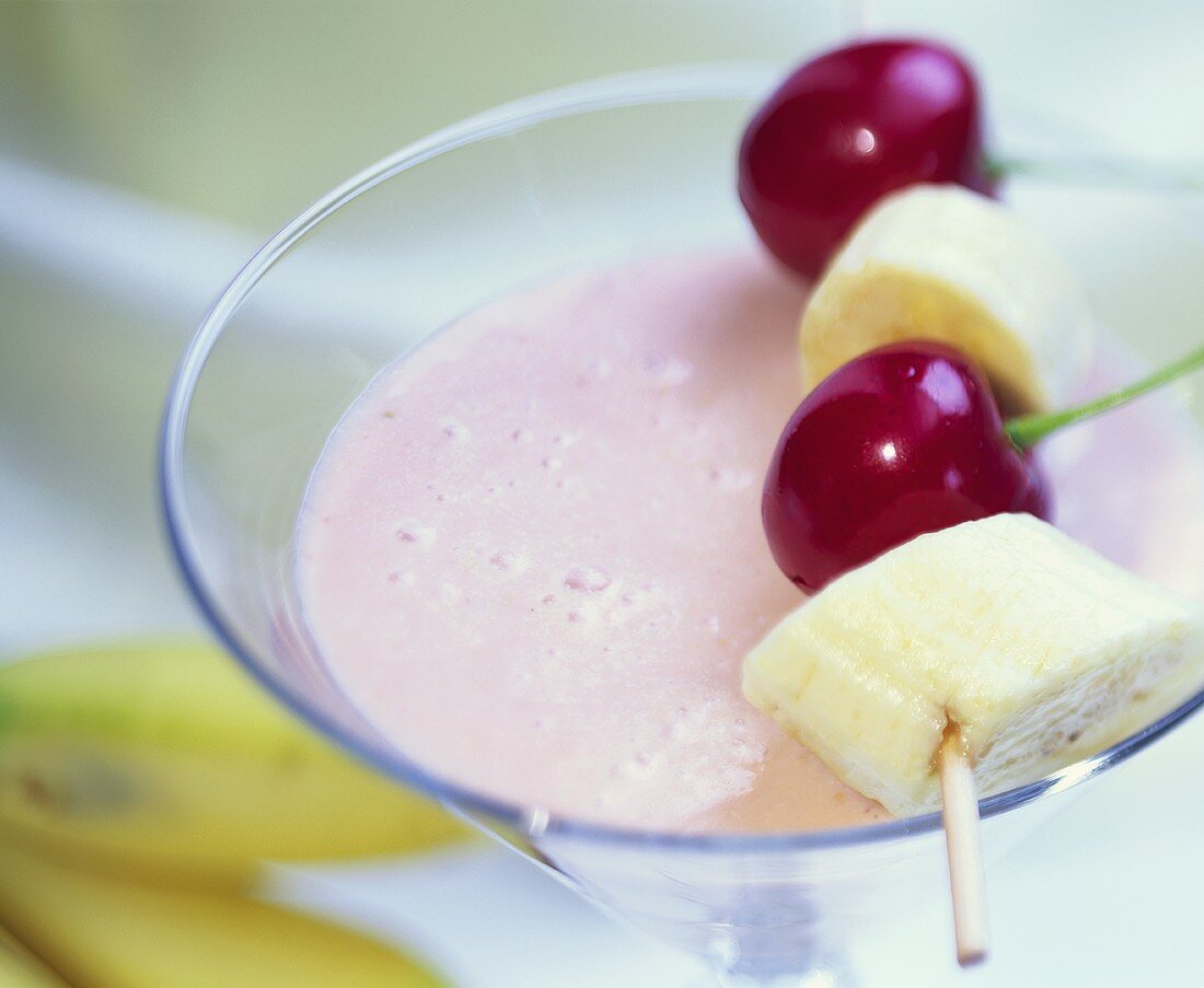 Cherry and banana shake with skewered fruit