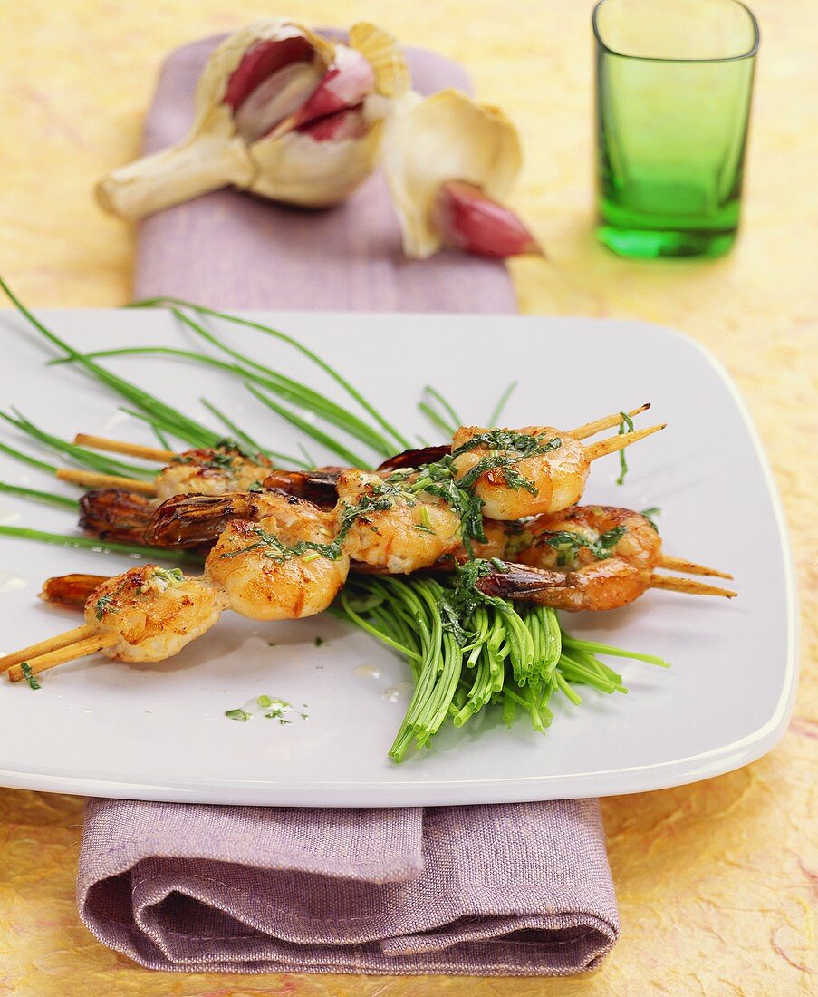 Shrimp kebabs with herb sauce cooked on "hot stone"