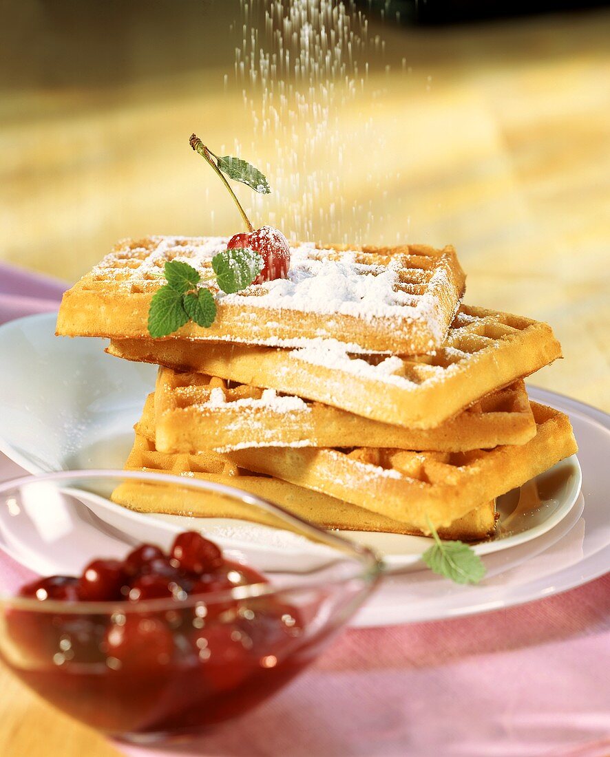 Vanilla waffles with cherry compote and icing sugar