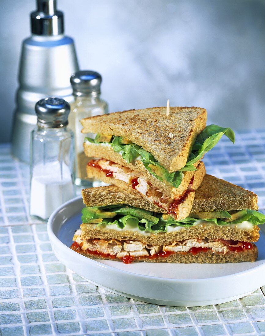 Club sandwich with chicken, lettuce and ketchup