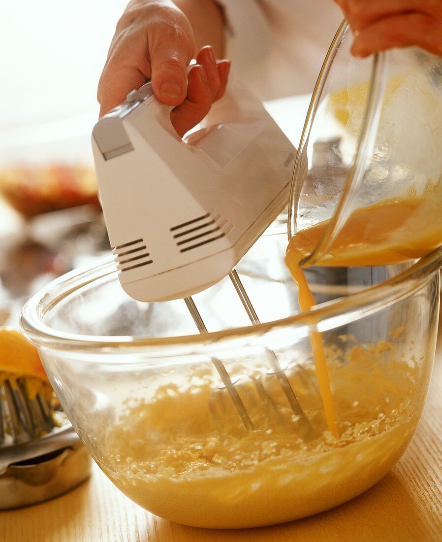 Whisking eggs in a bowl with hand mixer