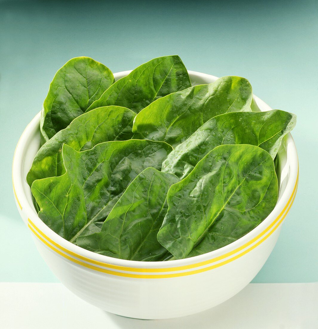 Large spinach leaves in a dish