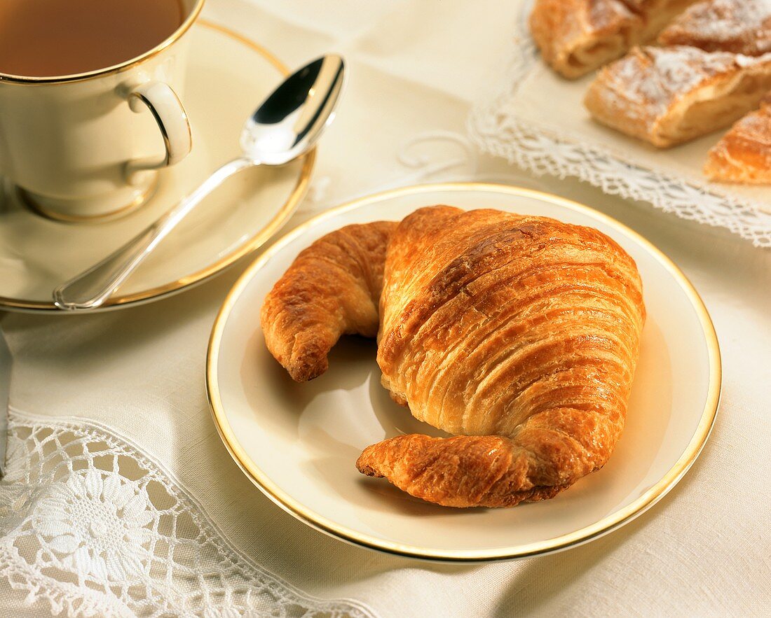 Croissant on a gold-rimmed plate