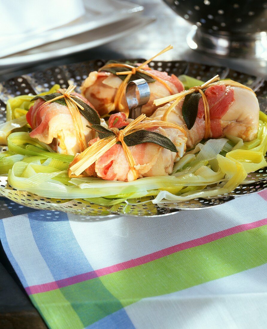 Chicken parcels with bacon and sage steamed on a bed of leeks