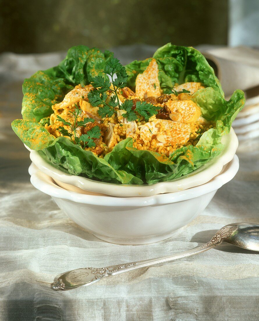 Millet-coated chicken breast on salad leaves