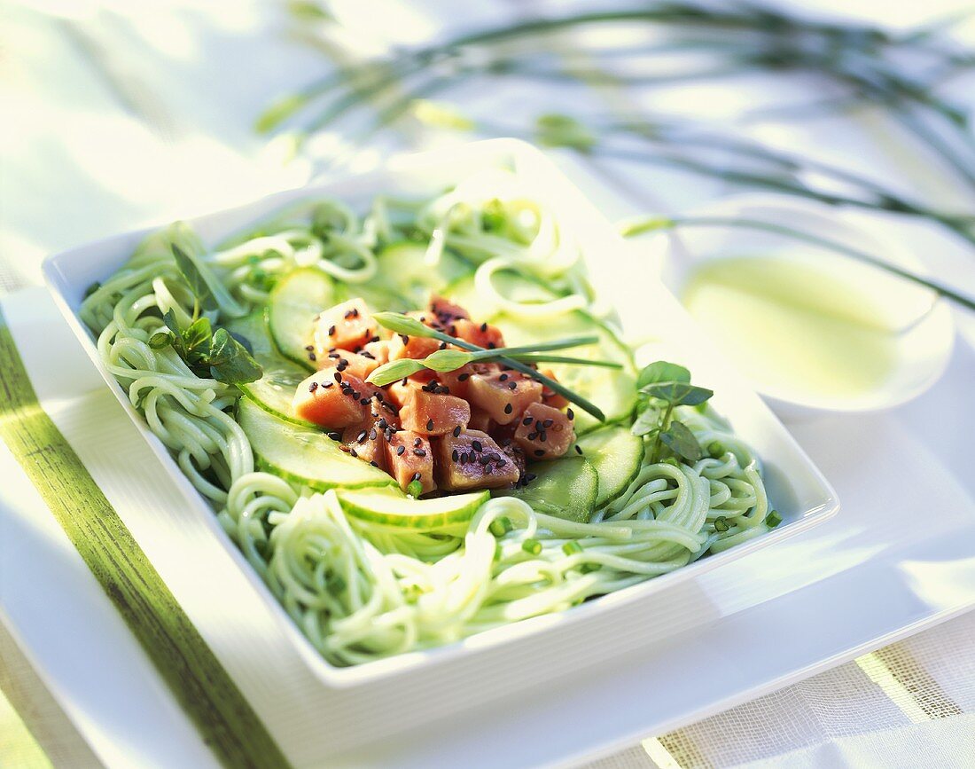Green rice noodle salad with cucumber & pieces of raw tuna