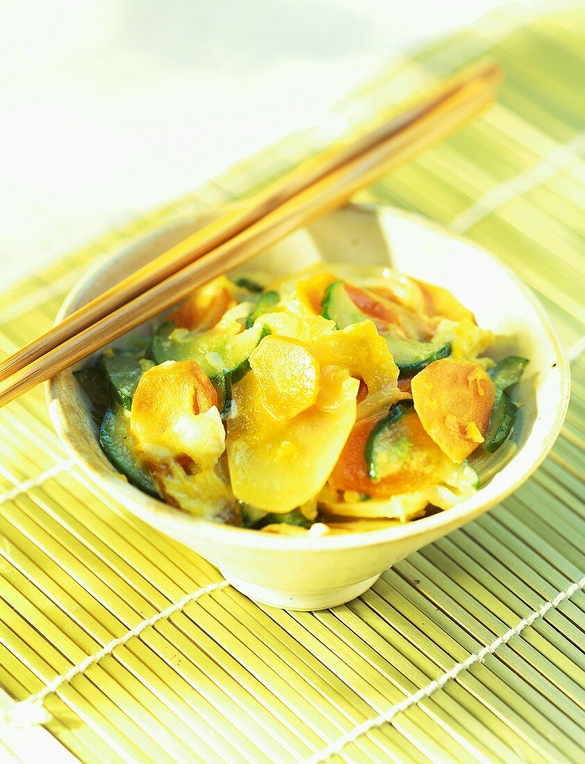 Vegetable curry in bowl with chopsticks