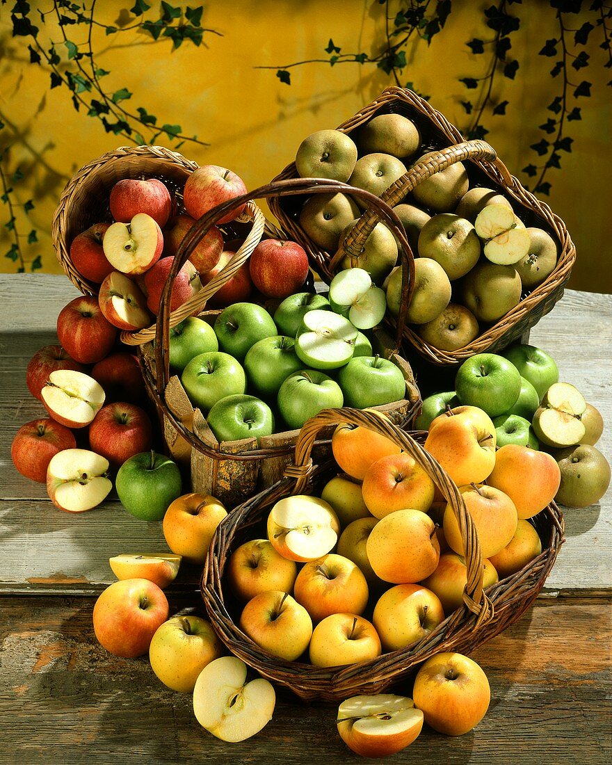 Four baskets of different types of apples