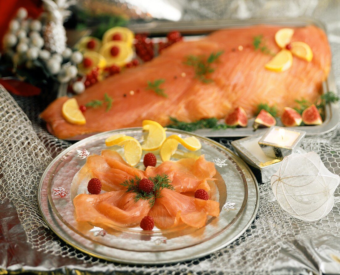 Smoked salmon decorated with raspberries and lemon slices