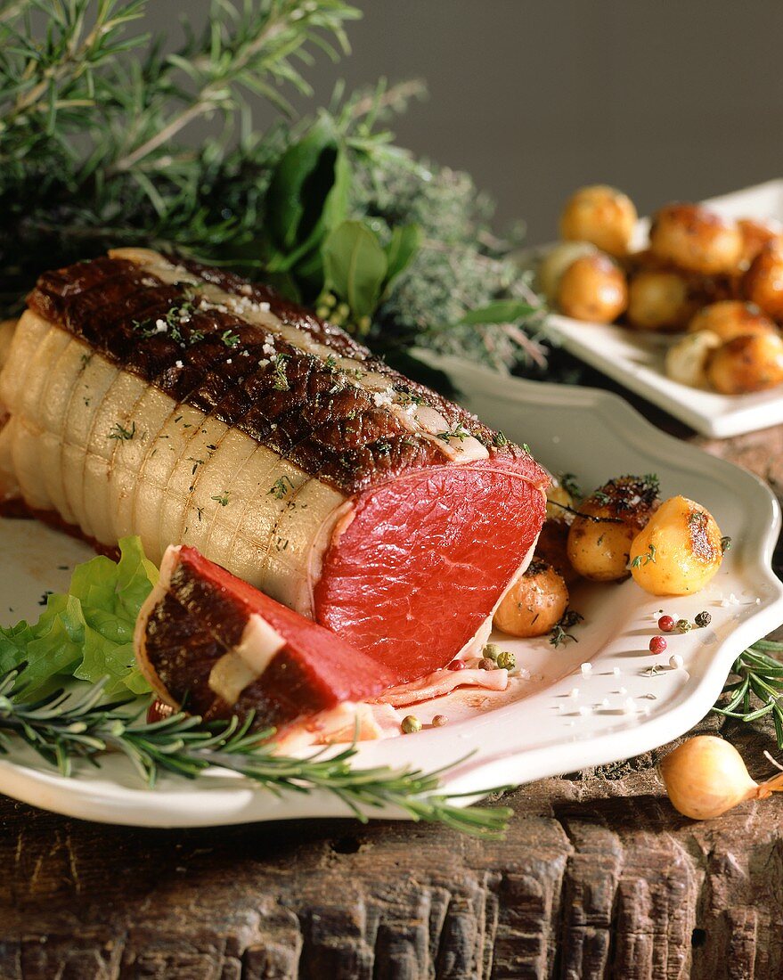 Roast beef roll with fresh herbs and potatoes