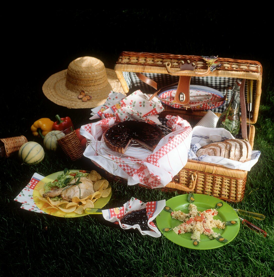 Picnic basket with food, sun hat
