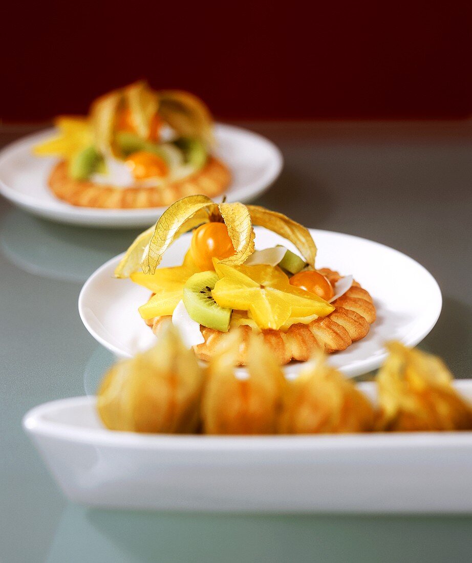 Tartlets with exotic fruit and slices of coconut
