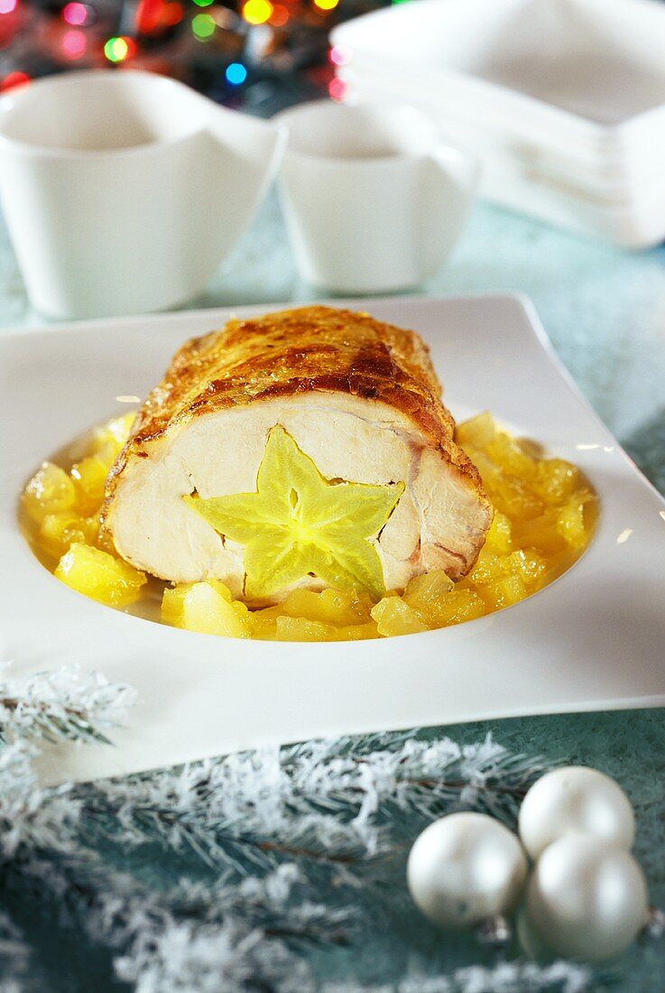 Roast pork stuffed with carambola, on apple compote