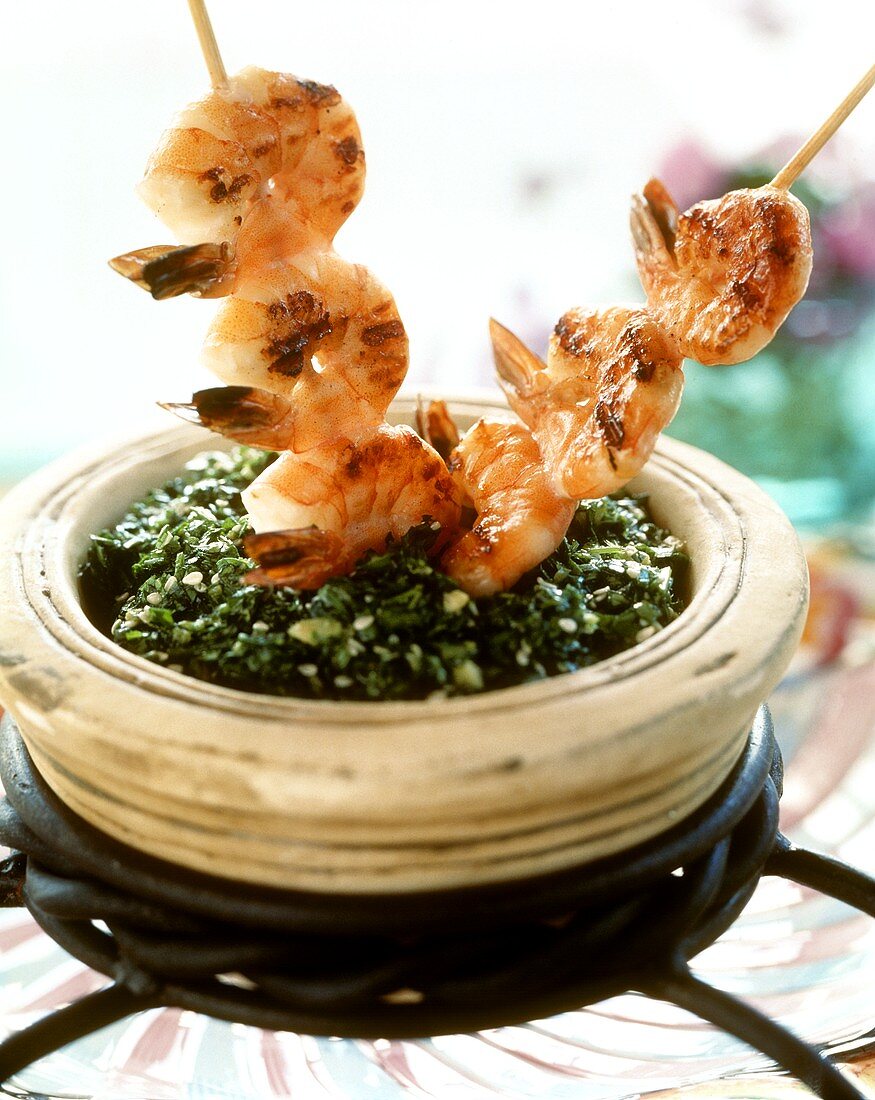 Shrimp kebabs on spinach with sesame