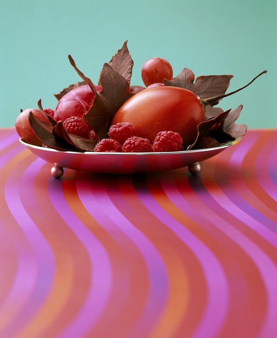 Silver bowl of autumn leaves and fruit