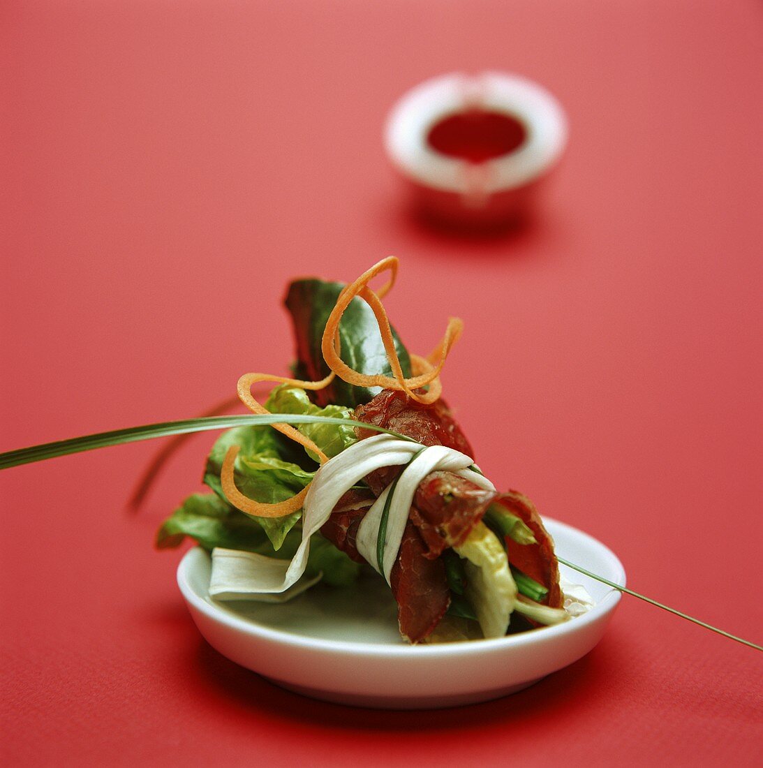 Bundle of fresh salad leaves wrapped in air-dried beef