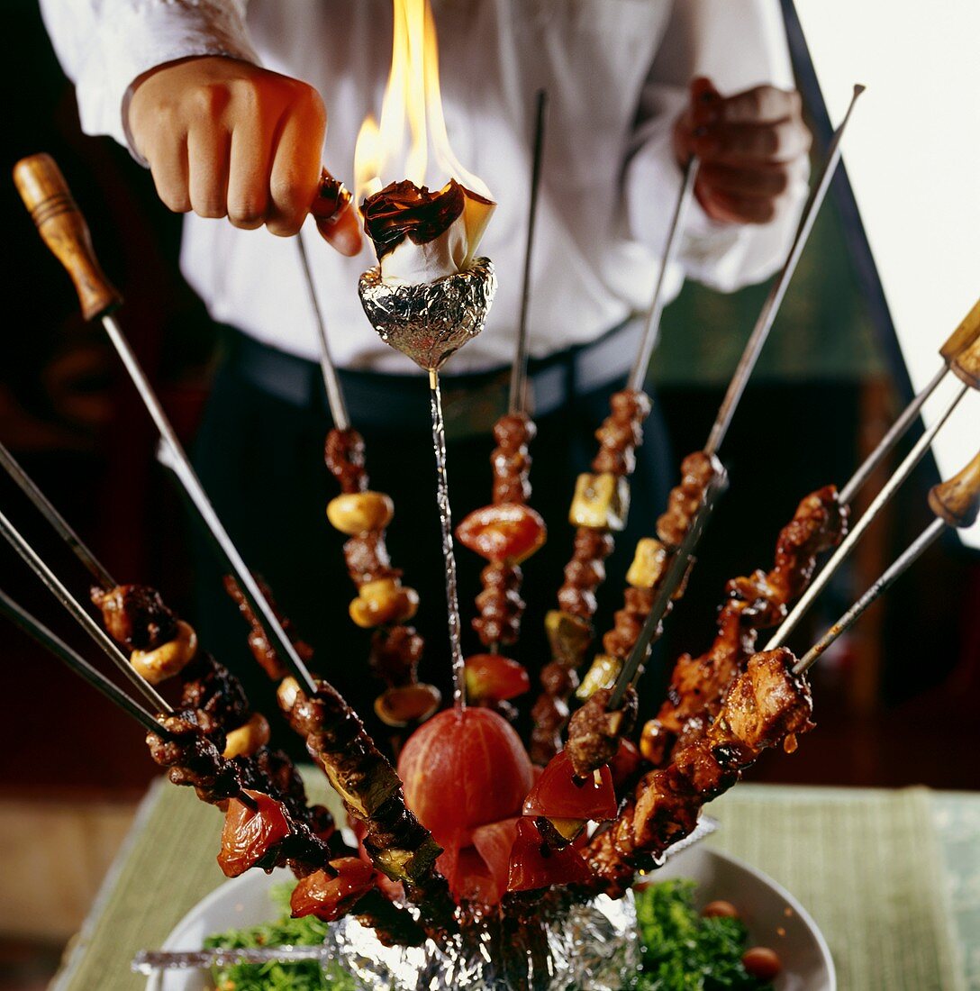 Several fried meat kebabs in a bundle