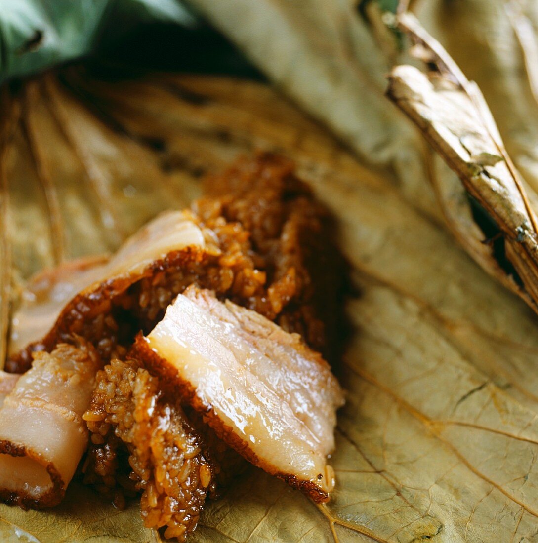 Roast pork with sticky rice on a lotus leaf